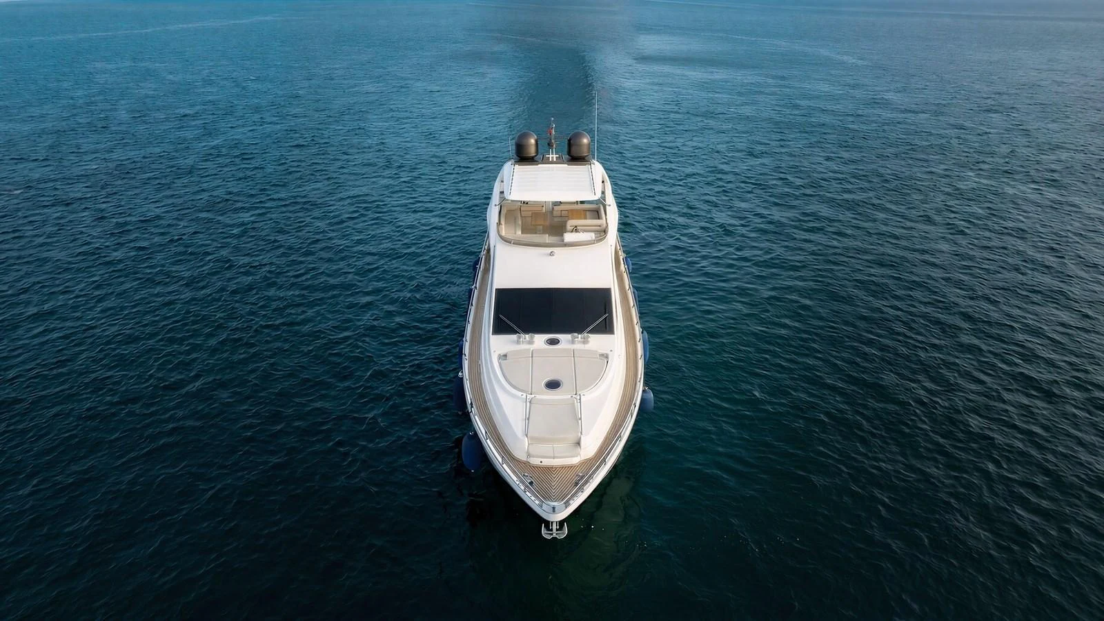 A sleek yacht glides gracefully on calm waters, showcasing its elegant design from a head-on perspective. aboard SEA PEARL 2 Yacht for Sale