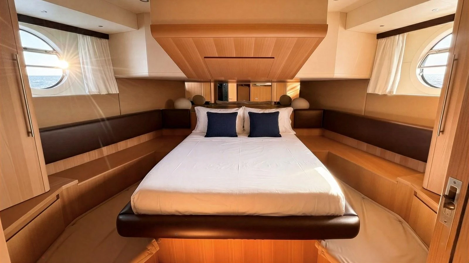 The stateroom features a luxurious bed with elegant bedding and ample natural light from the portholes. aboard SEA PEARL 2 Yacht for Sale