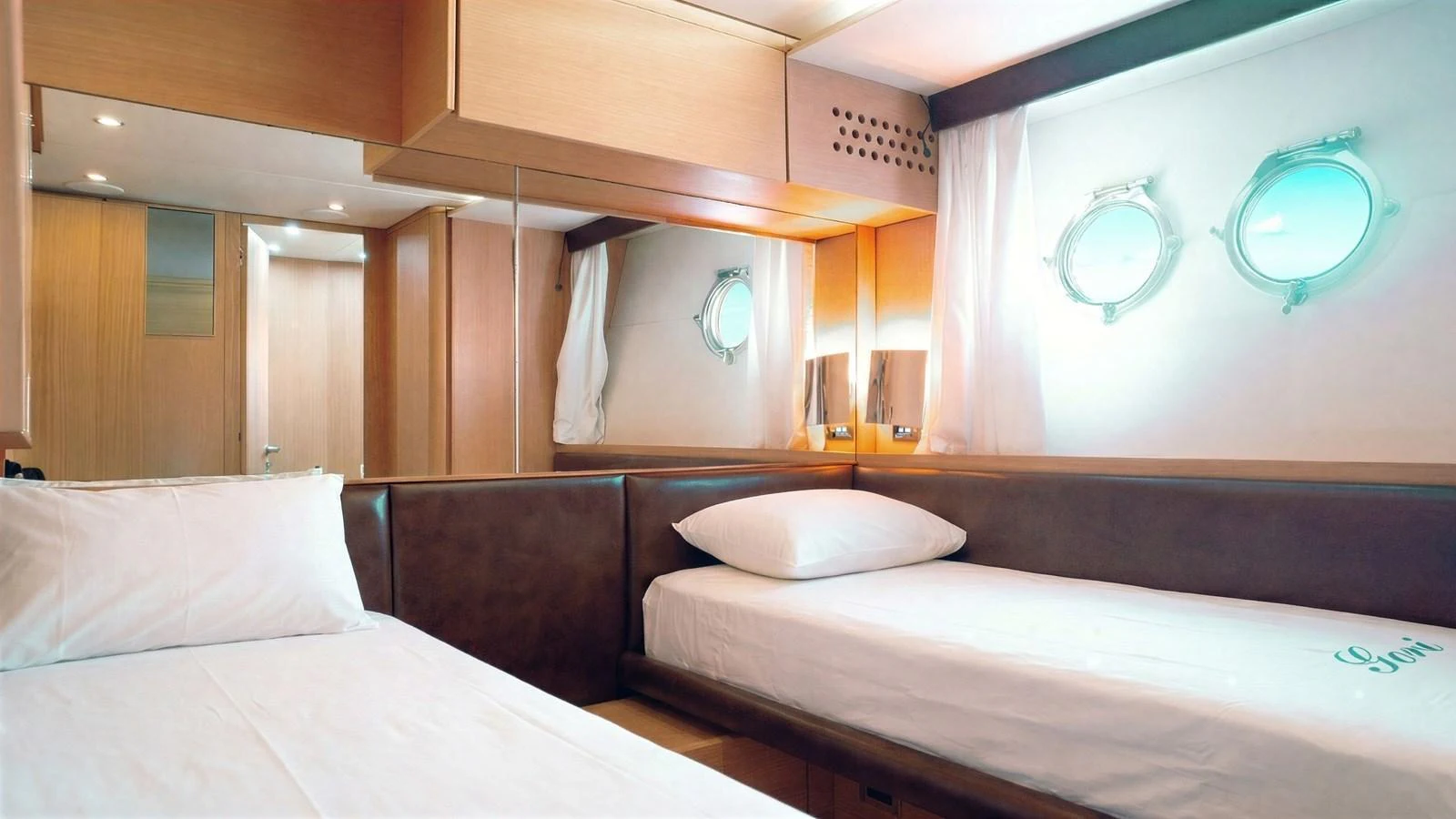 The guest cabin features twin beds, porthole windows, and a warm, inviting ambiance. aboard SEA PEARL 2 Yacht for Sale