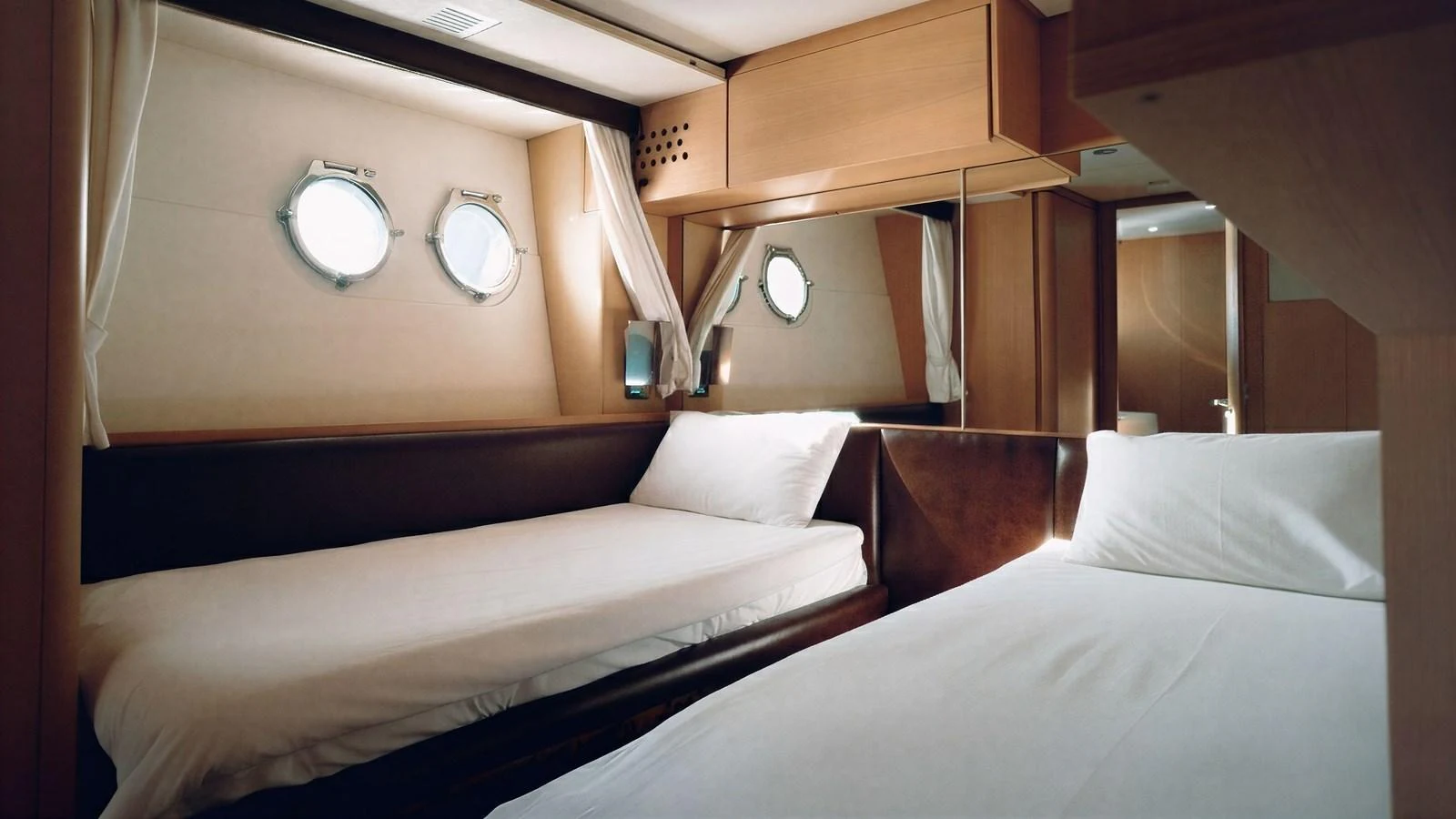 The guest stateroom features twin beds and porthole windows, creating a cozy and inviting atmosphere. aboard SEA PEARL 2 Yacht for Sale