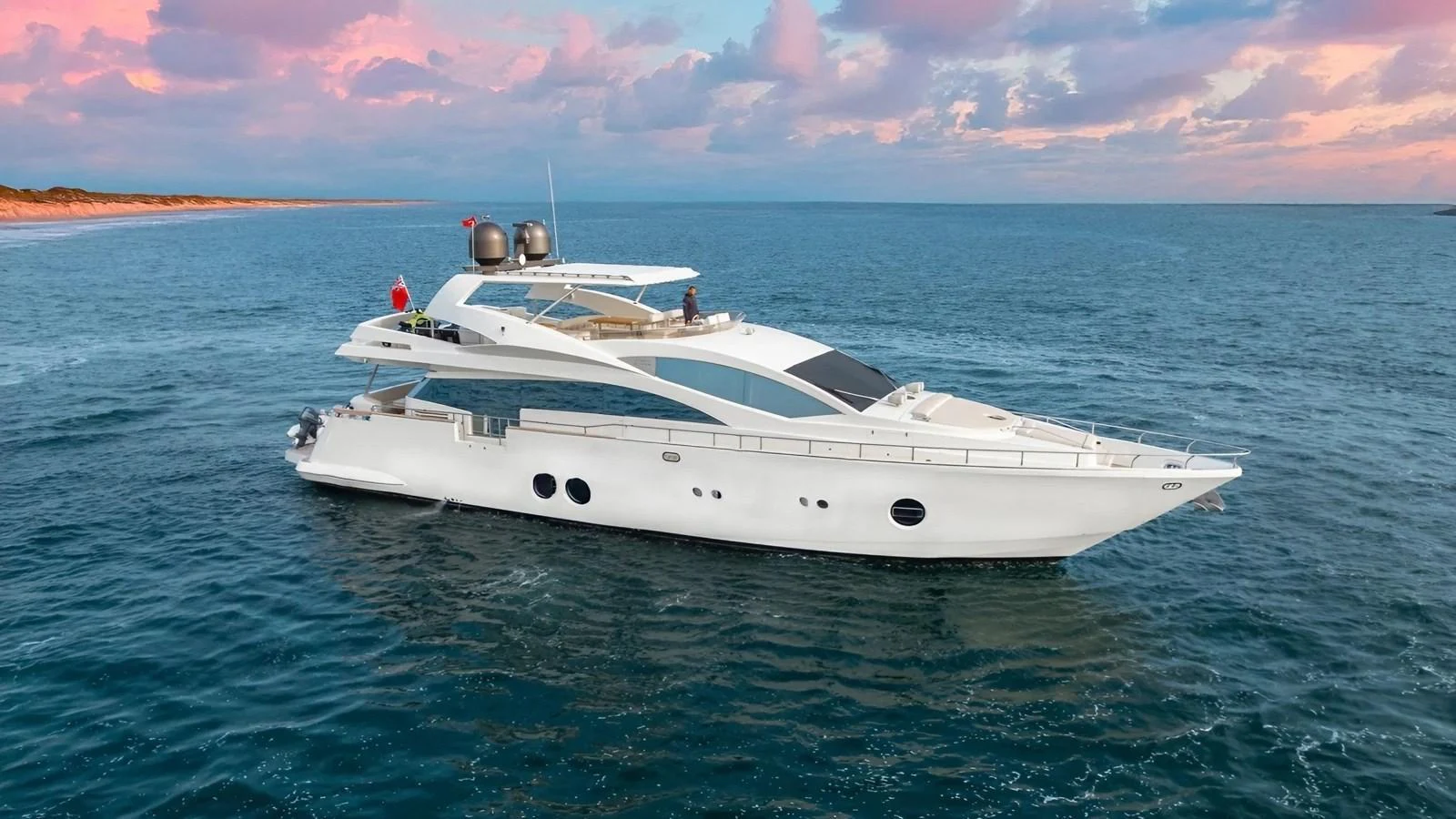 A sleek and modern yacht cruising on calm waters under a picturesque sky. aboard SEA PEARL 2 Yacht for Sale