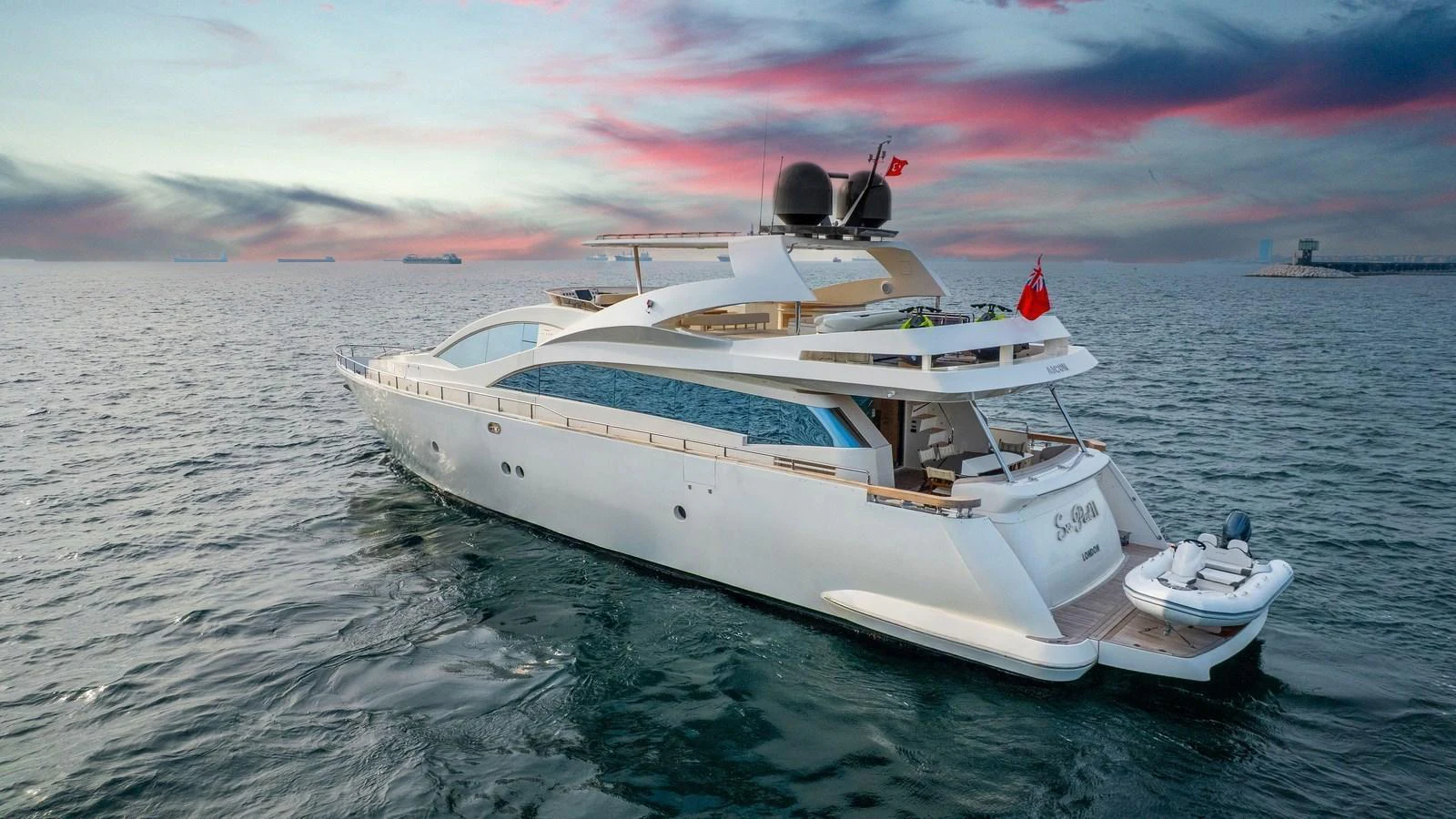 A sleek and modern yacht glides gracefully on the open water at sunset. aboard SEA PEARL 2 Yacht for Sale