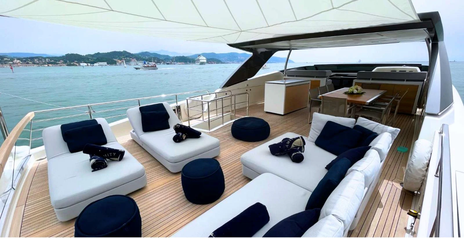 a large white lounge chair on a boat with a large body of water and a large white lounge aboard AMAN - SL96 Yacht for Sale