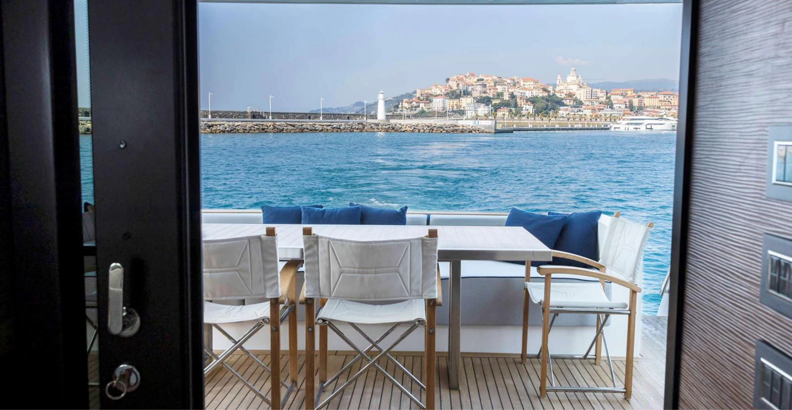 a table and chairs on a balcony overlooking a body of water aboard AMAN - SL96 Yacht for Sale