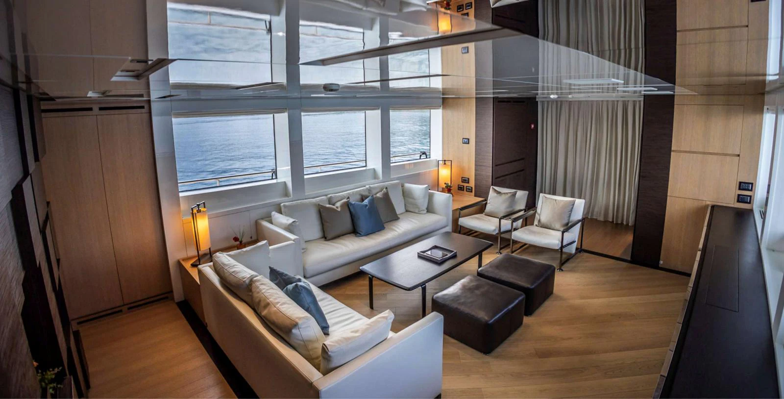 a living room with a couch and a table aboard AMAN - SL96 Yacht for Sale
