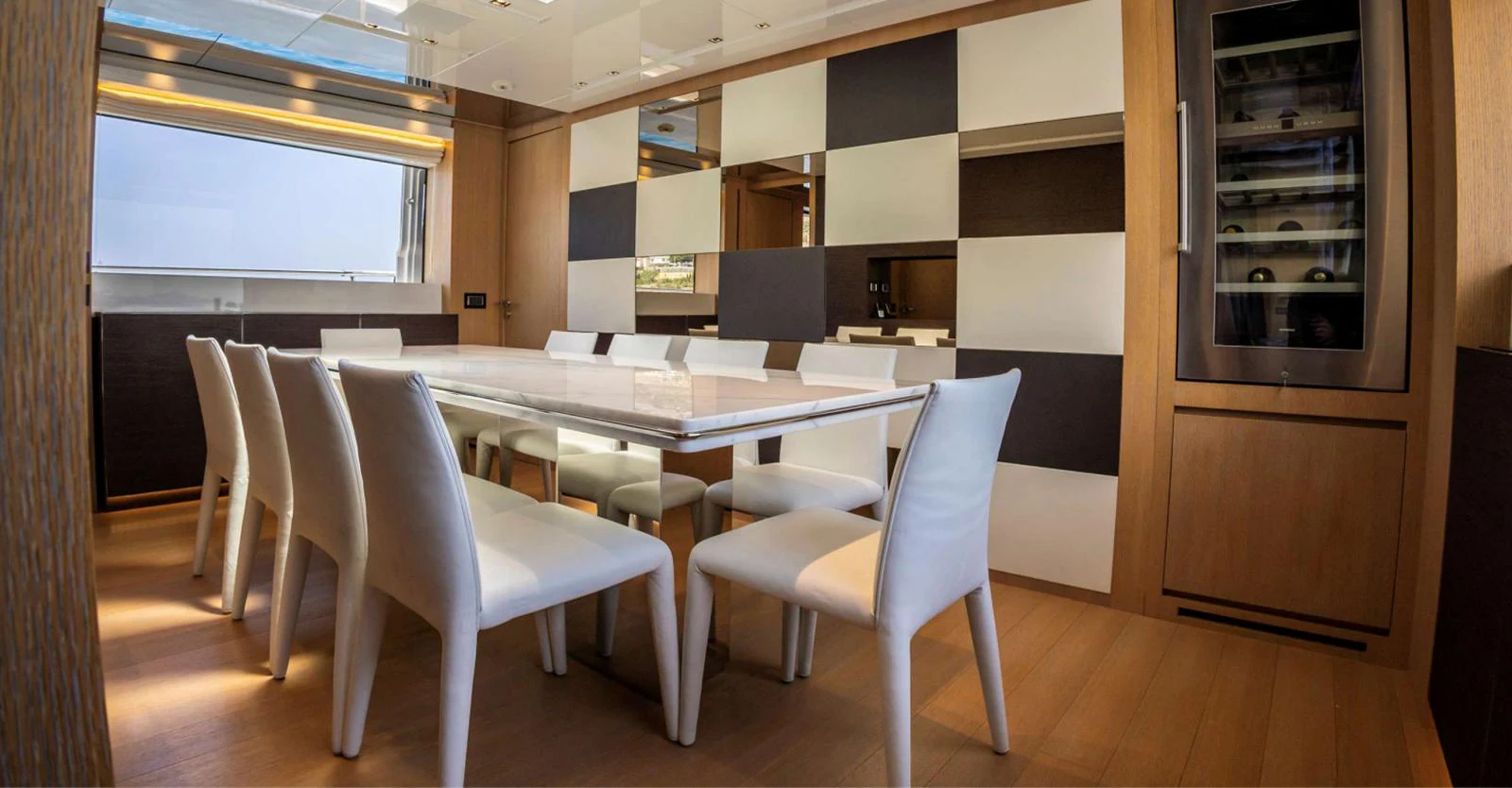 a room with a table chairs and cabinets aboard AMAN - SL96 Yacht for Sale