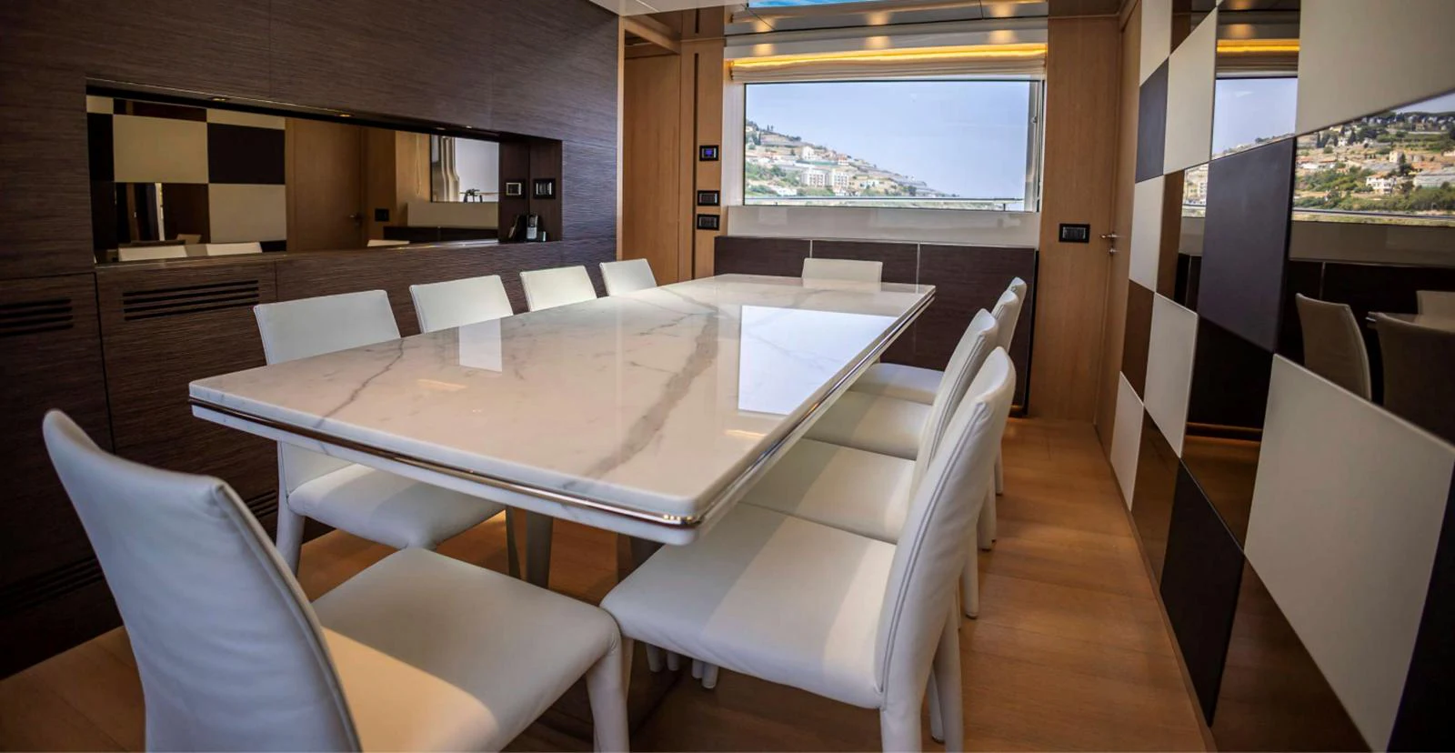 a room with a table chairs and a window aboard AMAN - SL96 Yacht for Sale