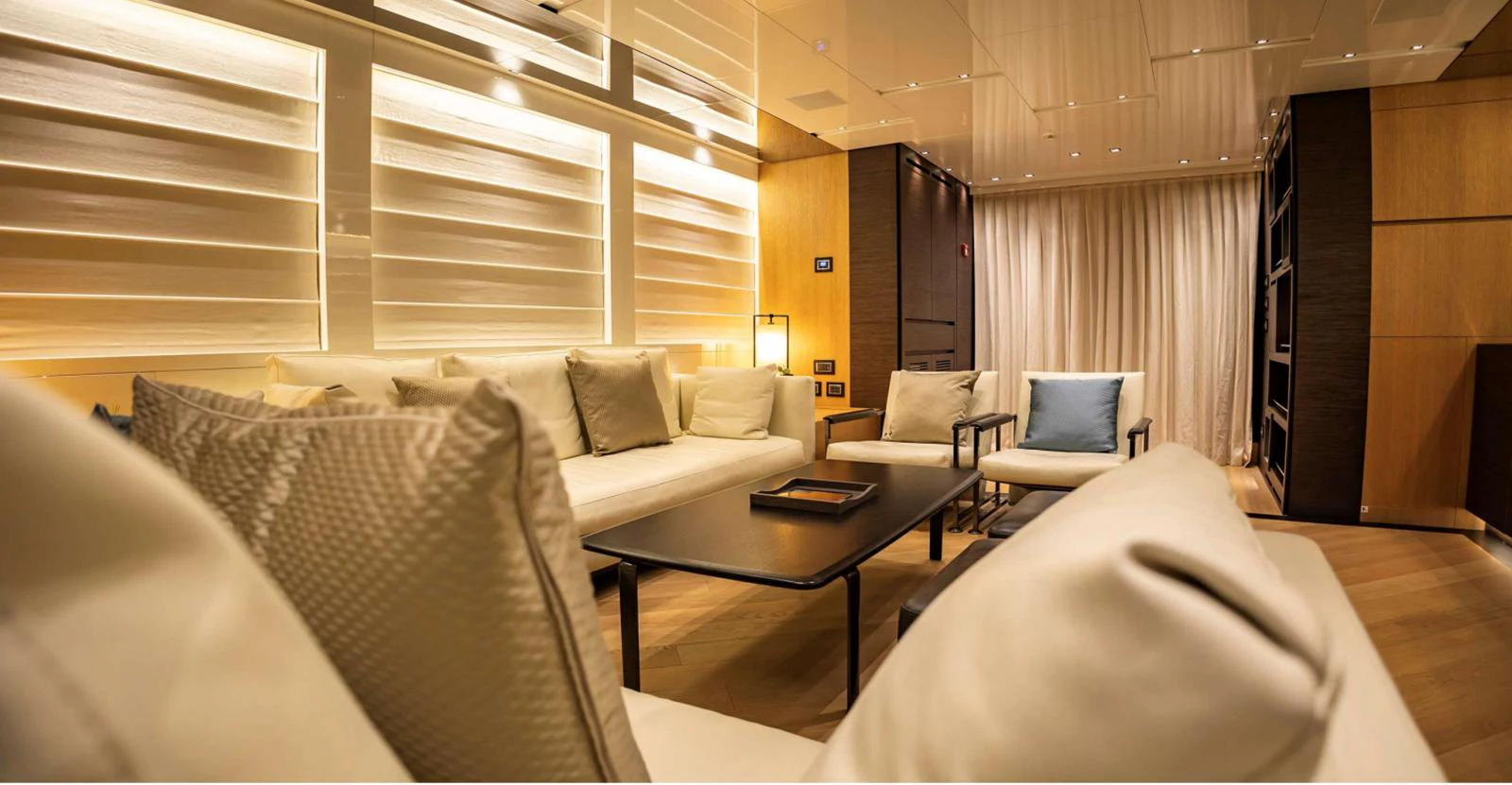 a room with couches and a coffee table aboard AMAN - SL96 Yacht for Sale