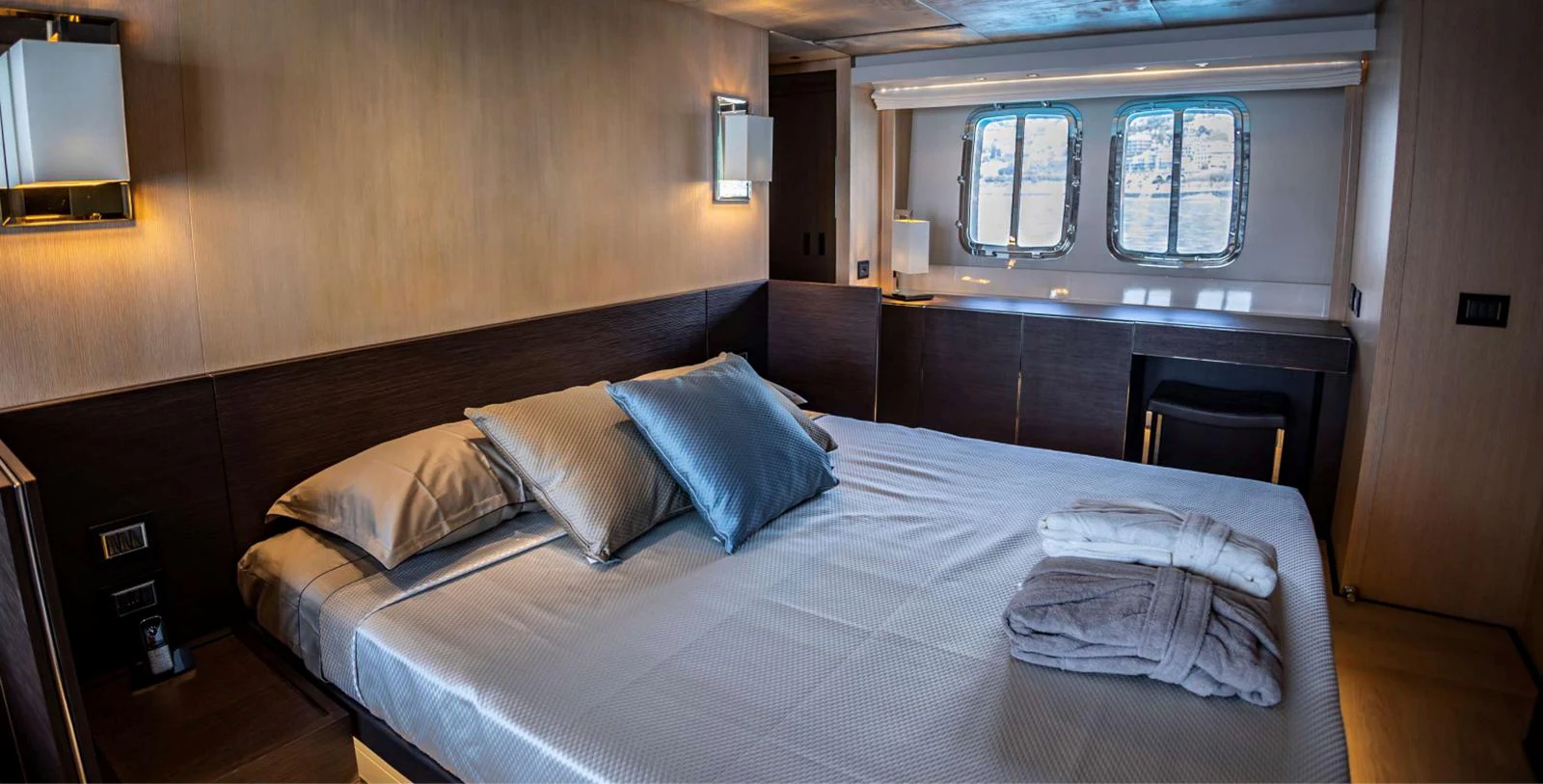 a bed with a blue pillow aboard AMAN - SL96 Yacht for Sale