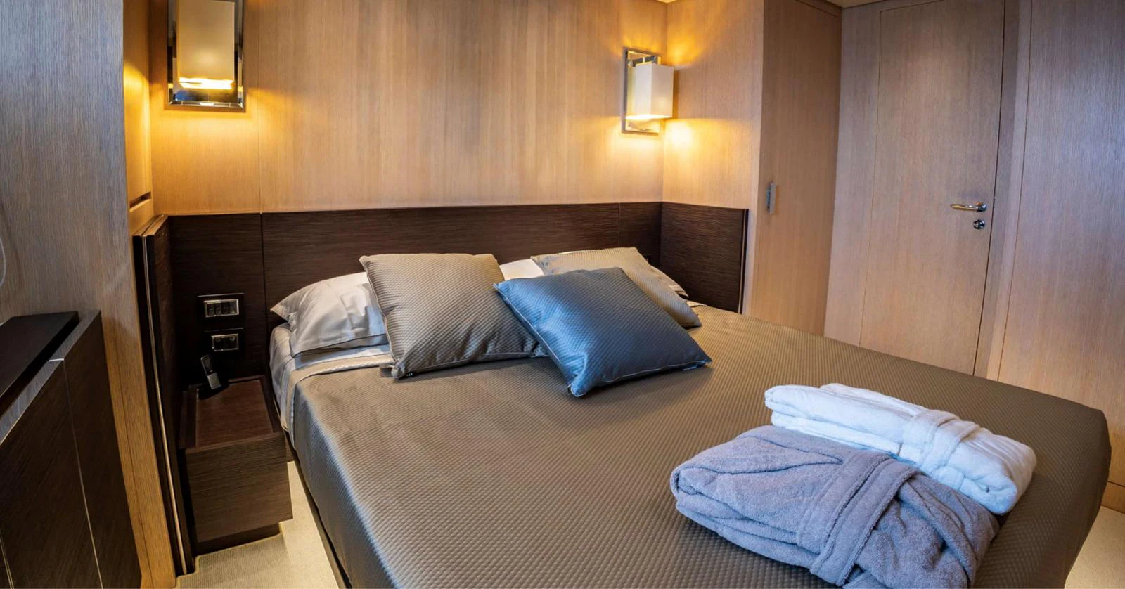 a bed with a blue pillow aboard AMAN - SL96 Yacht for Sale