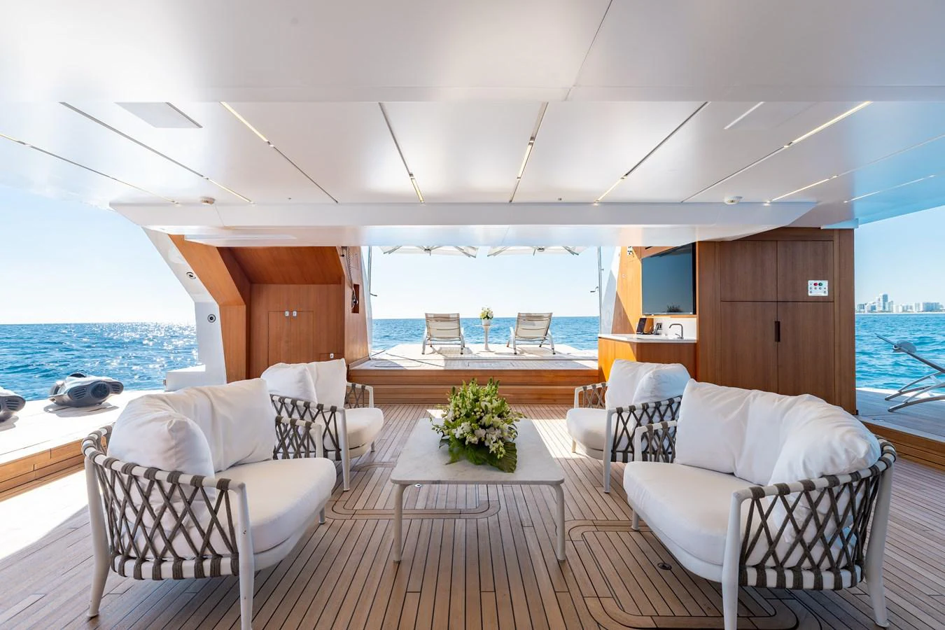 The aft deck features a luxurious seating area with a stunning view of the ocean. aboard NEVERLAND II Yacht for Sale