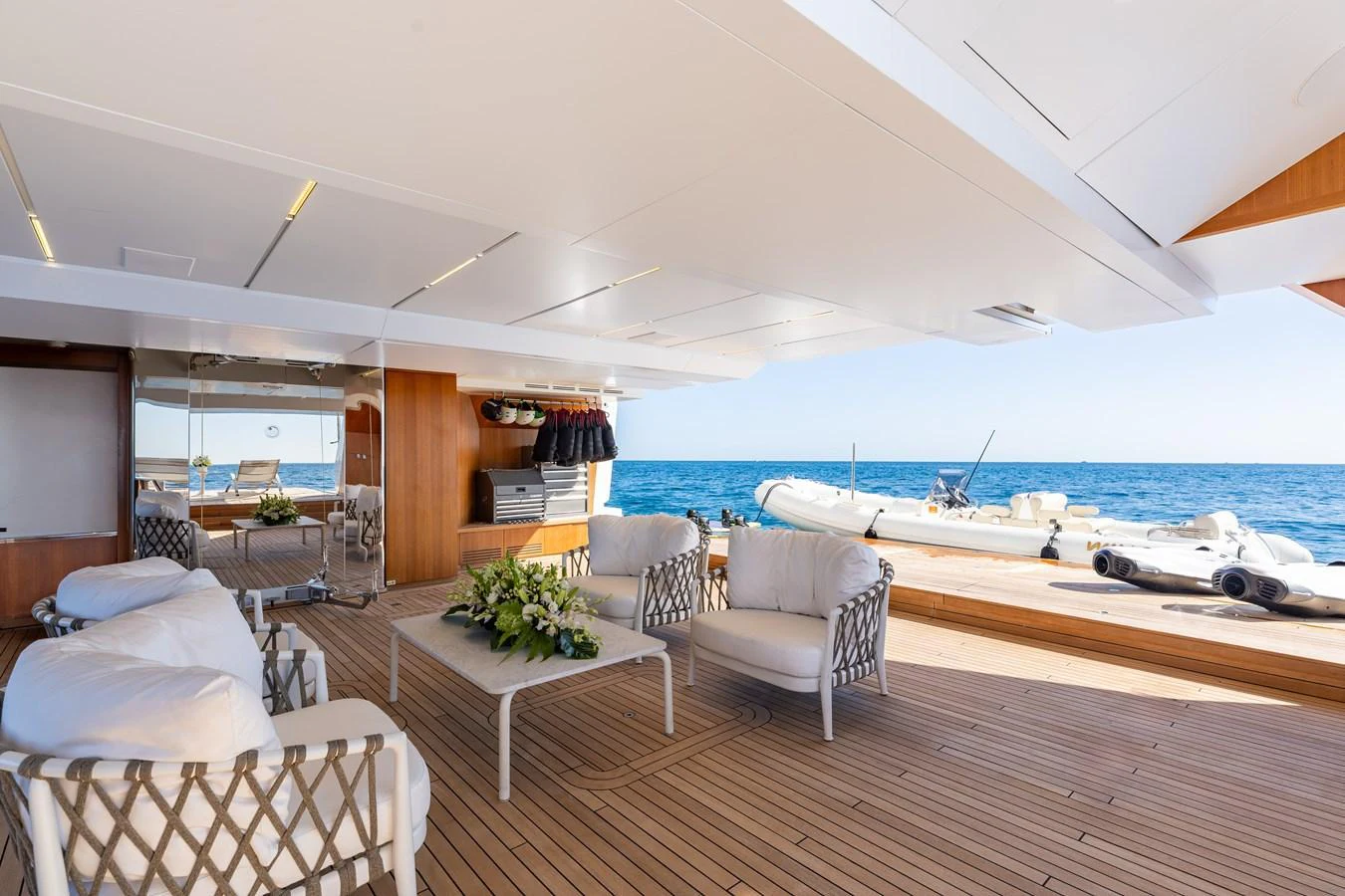 The aft deck features elegant seating with a view of the tender and the open sea. aboard NEVERLAND II Yacht for Sale