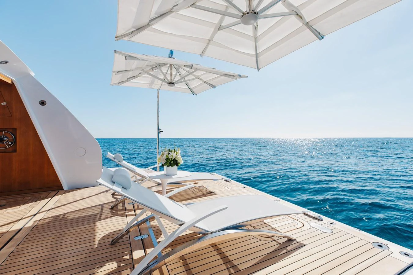The aft deck features luxurious sun loungers and umbrellas, perfect for relaxing by the sea. aboard NEVERLAND II Yacht for Sale