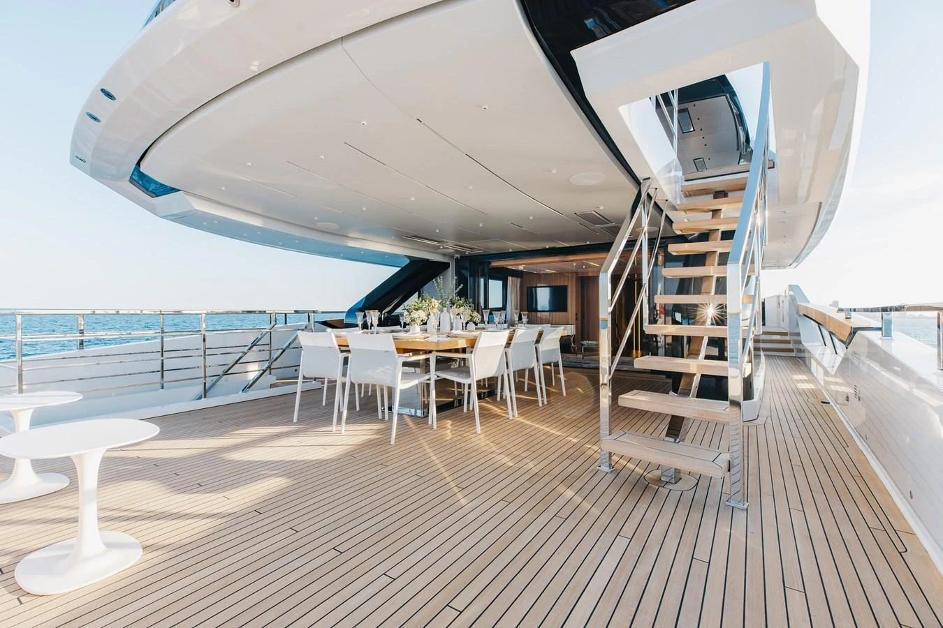 The spacious aft deck features elegant dining and lounging areas with a stunning view of the sea. aboard NEVERLAND II Yacht for Sale