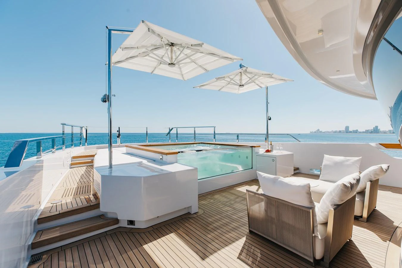 The sundeck features a luxurious hot tub with comfortable seating and stunning ocean views. aboard NEVERLAND II Yacht for Sale