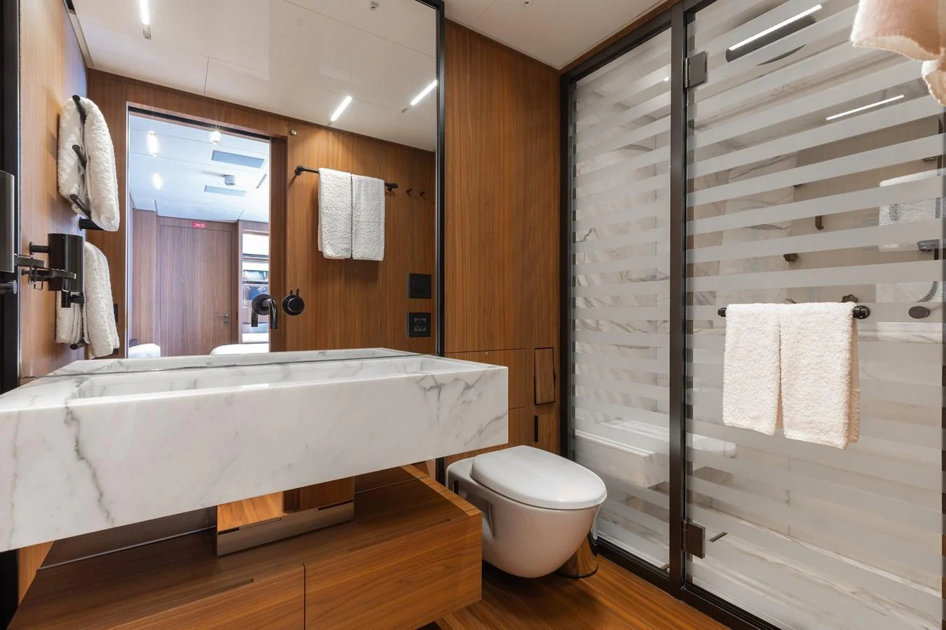The yacht's bathroom features a sleek design with a marble sink and modern fixtures. aboard NEVERLAND II Yacht for Sale