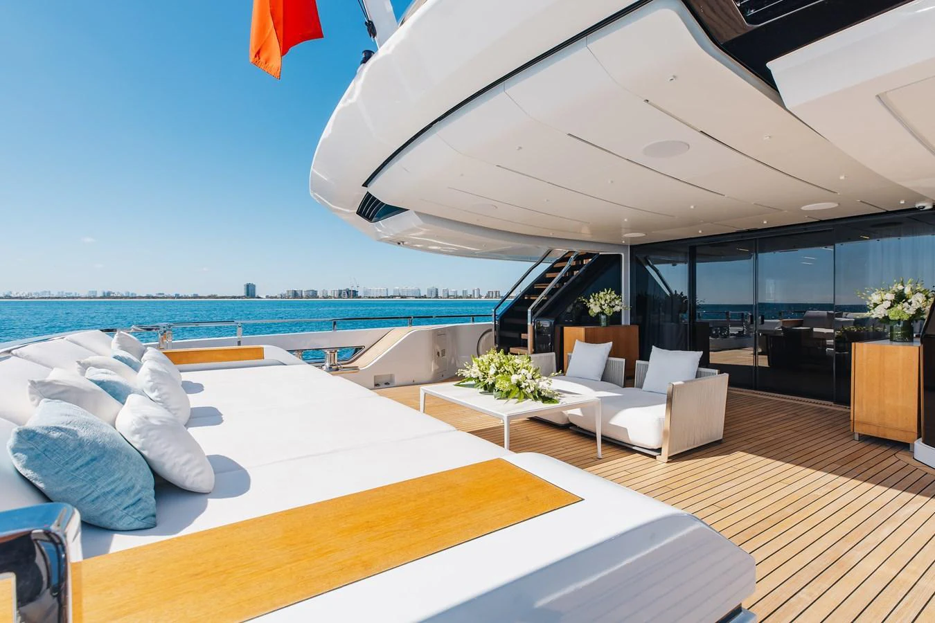 The spacious aft deck offers luxurious lounging with plush seating and stunning ocean views. aboard NEVERLAND II Yacht for Sale