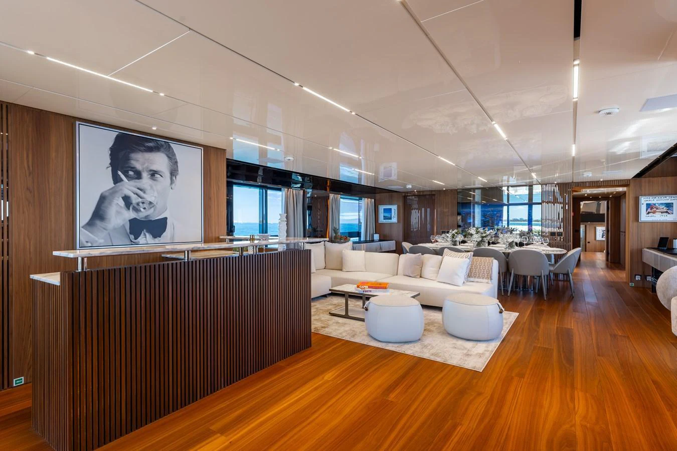 The yacht's salon features elegant wood paneling, plush seating, and modern decor. aboard NEVERLAND II Yacht for Sale