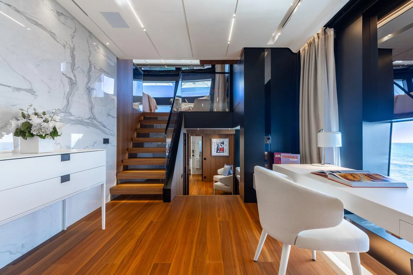 A luxurious interior space featuring elegant wood flooring and modern furnishings. aboard NEVERLAND II Yacht for Sale