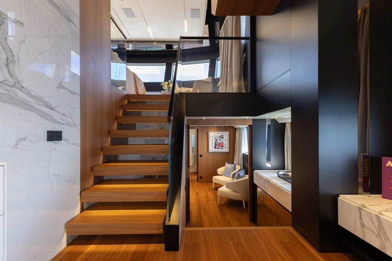 The yacht's interior features a modern staircase with sleek wooden steps and elegant marble accents. aboard NEVERLAND II Yacht for Sale