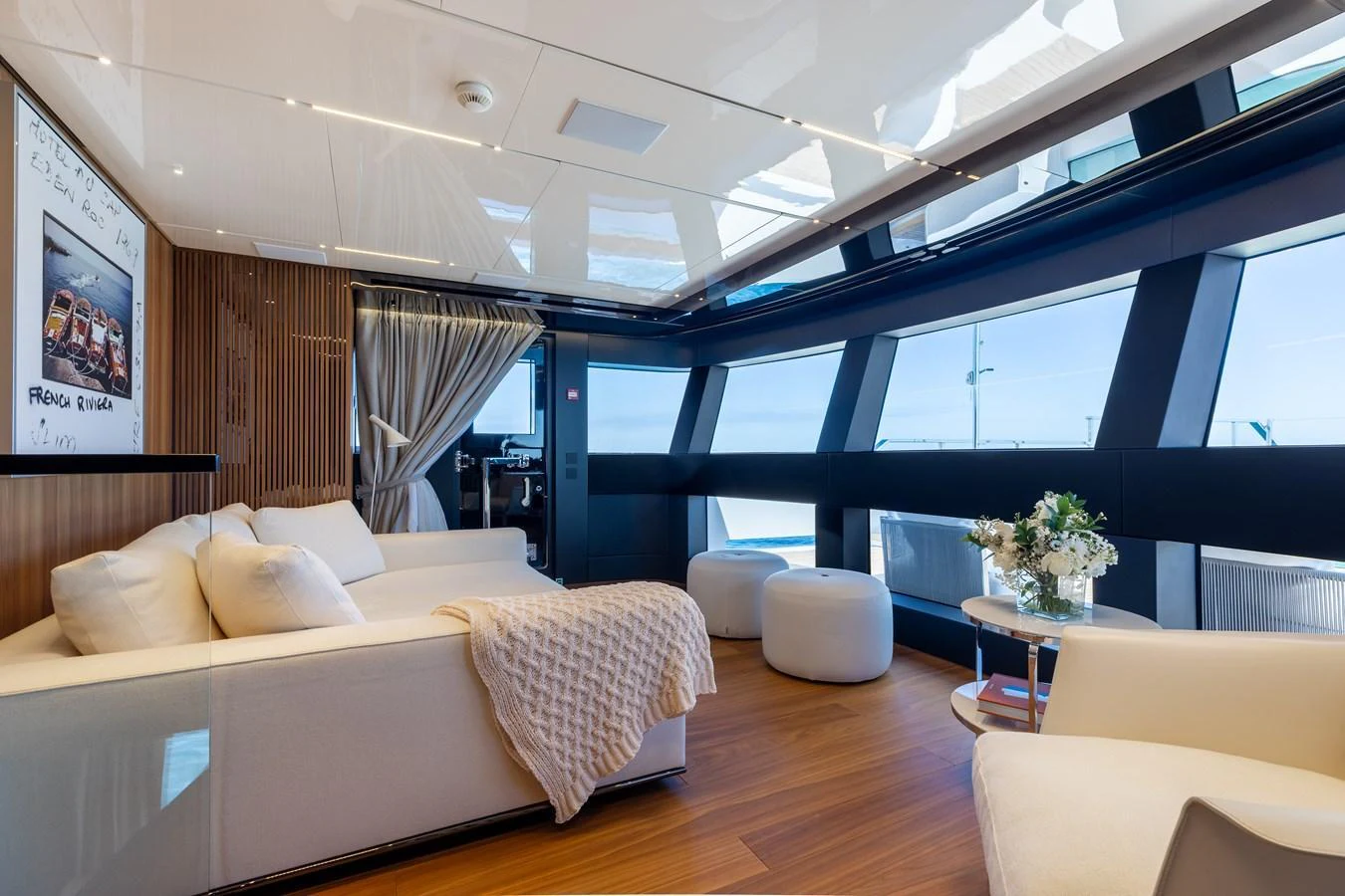 The yacht's interior features a luxurious and modern lounge area with ample natural light. aboard NEVERLAND II Yacht for Sale