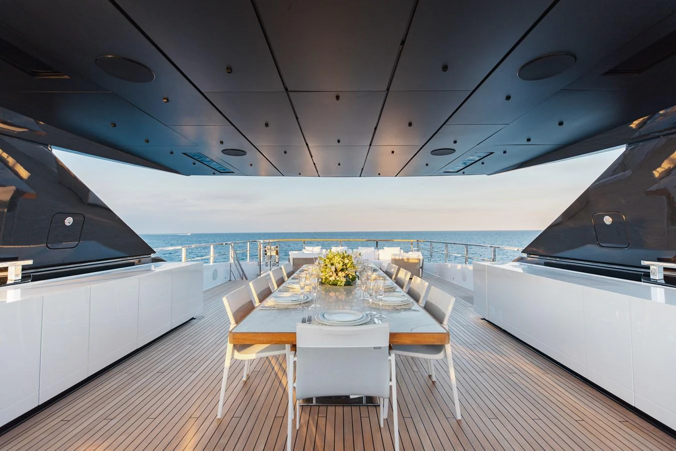 An elegant alfresco dining area on the yacht offers a stunning ocean view. aboard NEVERLAND II Yacht for Sale