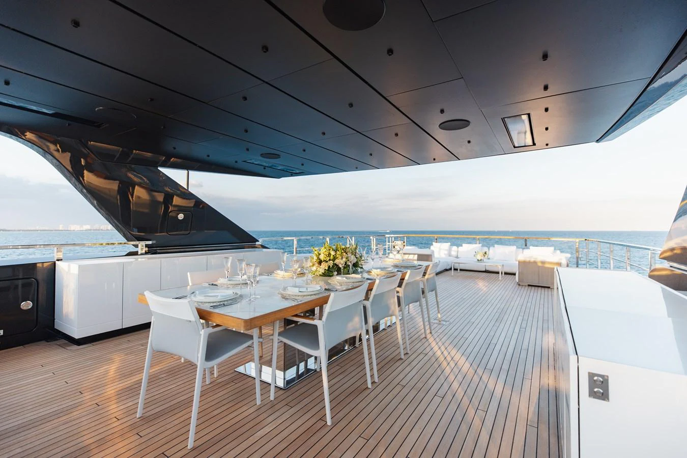 The aft deck features an elegant dining area with a stunning ocean view. aboard NEVERLAND II Yacht for Sale