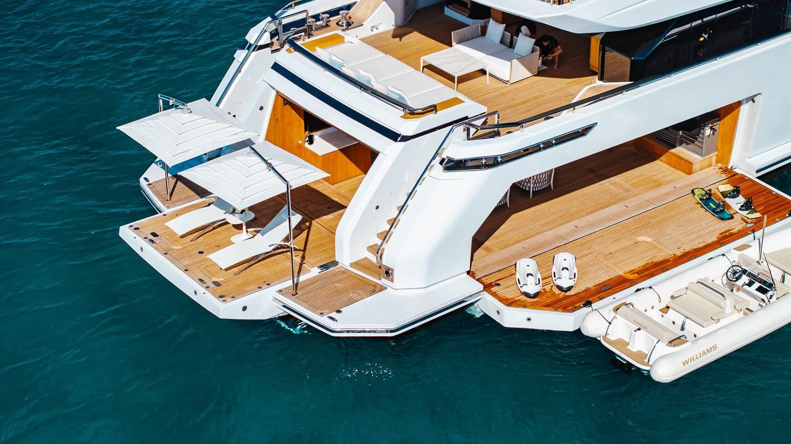 The yacht's aft deck features a spacious lounging area with direct access to the water. aboard NEVERLAND II Yacht for Sale