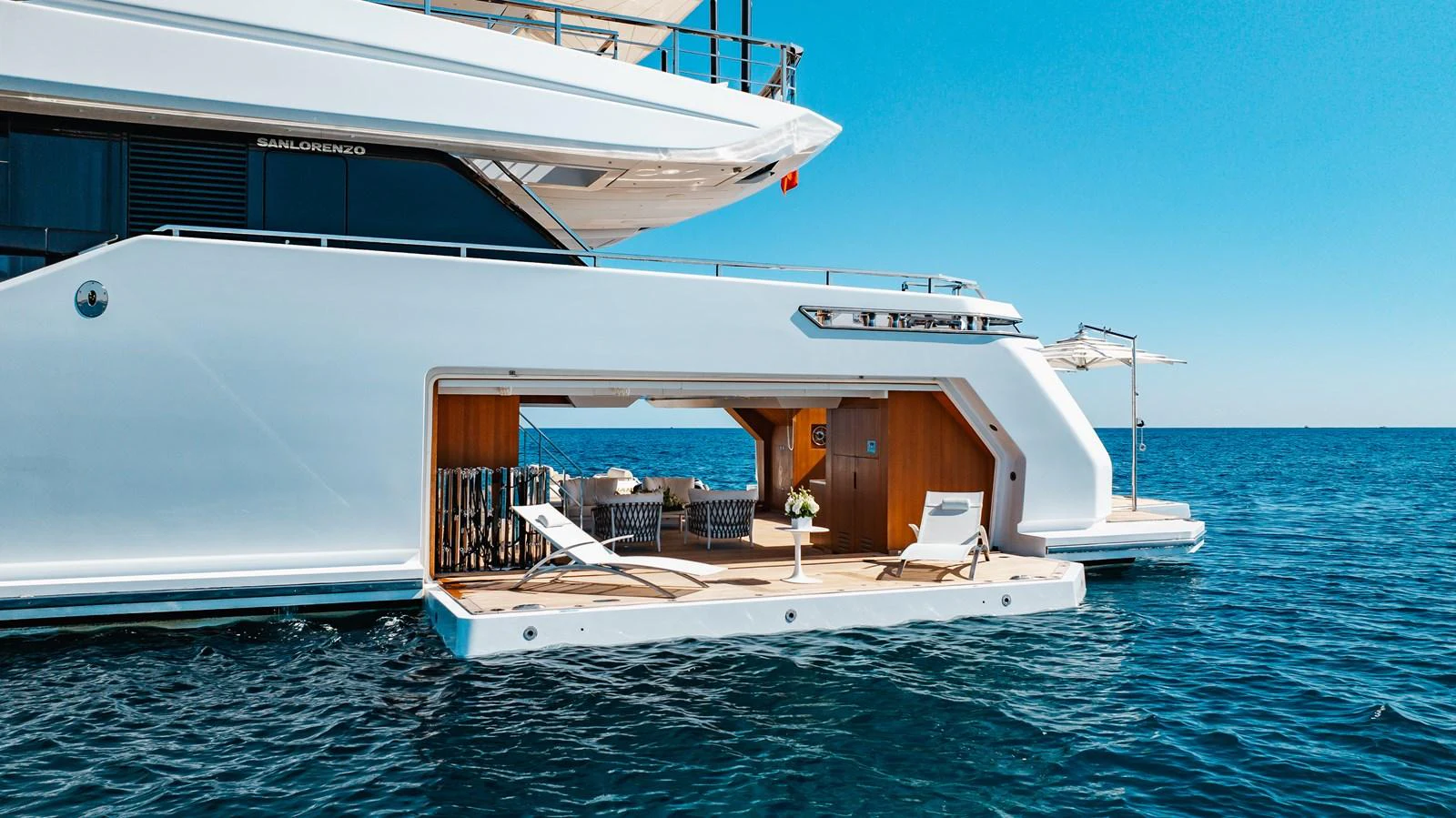The yacht features a luxurious beach club with sun loungers and direct access to the water. aboard NEVERLAND II Yacht for Sale