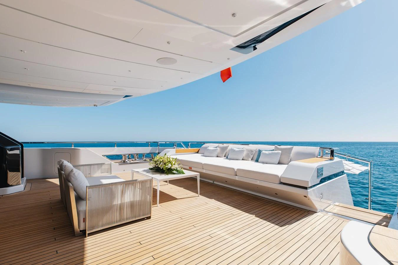 The aft deck offers a spacious lounging area with comfortable seating and stunning ocean views. aboard NEVERLAND II Yacht for Sale