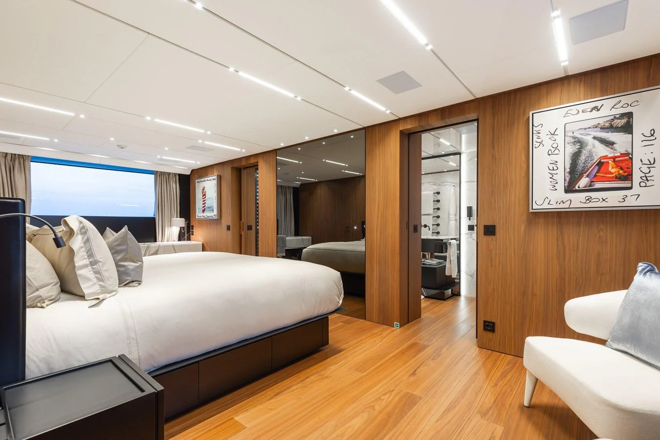 The master stateroom features a spacious layout with elegant wood paneling and modern decor. aboard NEVERLAND II Yacht for Sale