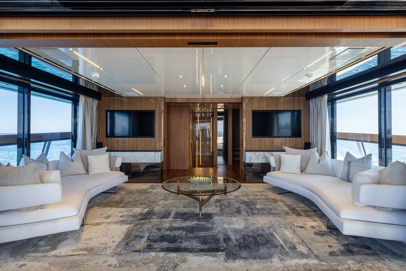 The yacht's salon features luxurious seating with panoramic views and elegant decor. aboard NEVERLAND II Yacht for Sale