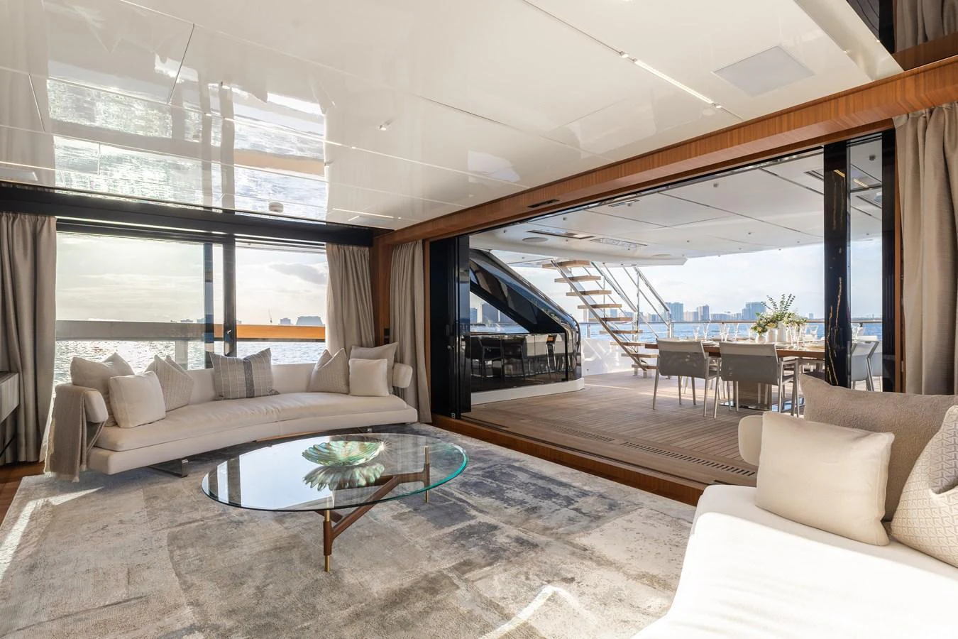The spacious salon features elegant seating and expansive views, seamlessly connecting to the aft deck. aboard NEVERLAND II Yacht for Sale