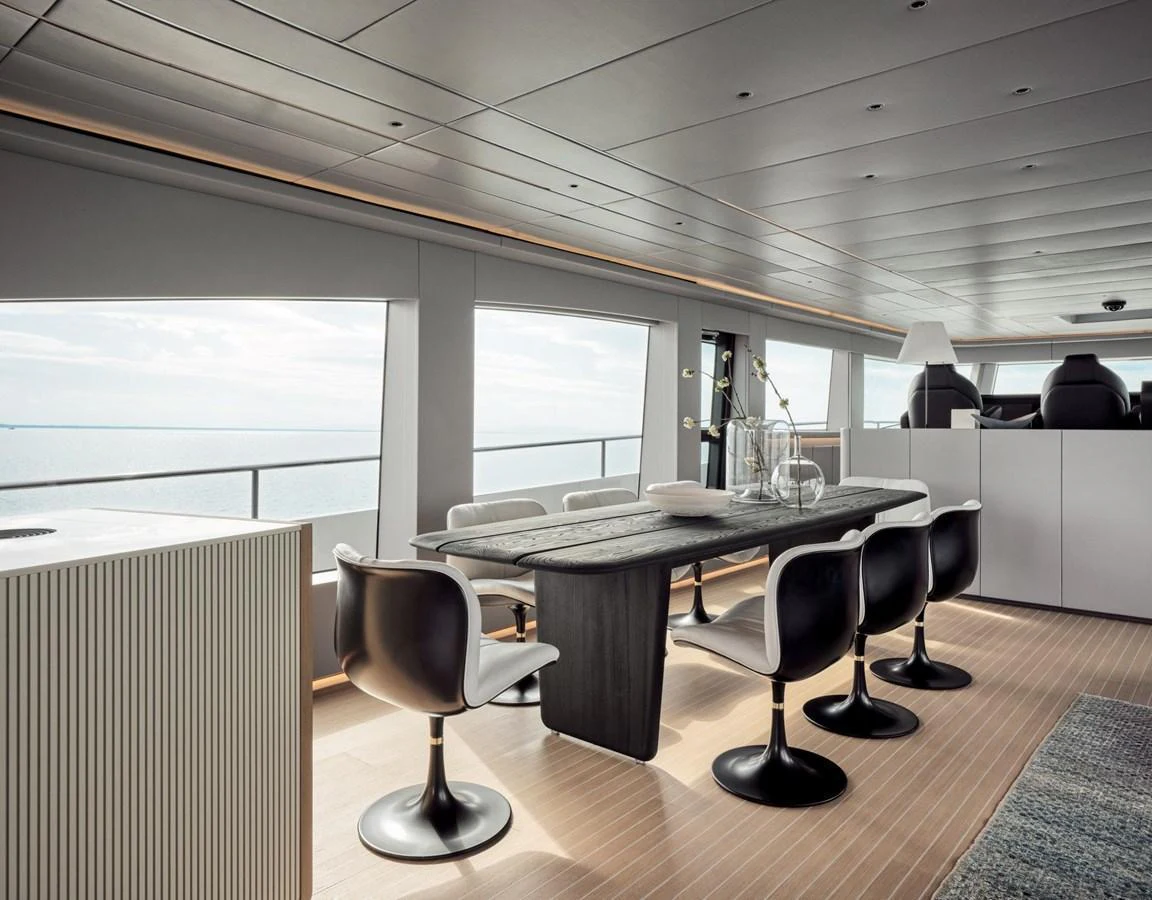The yacht's dining area features a sleek, modern design with panoramic ocean views. aboard 50 SHADES OF PLAY Yacht for Sale