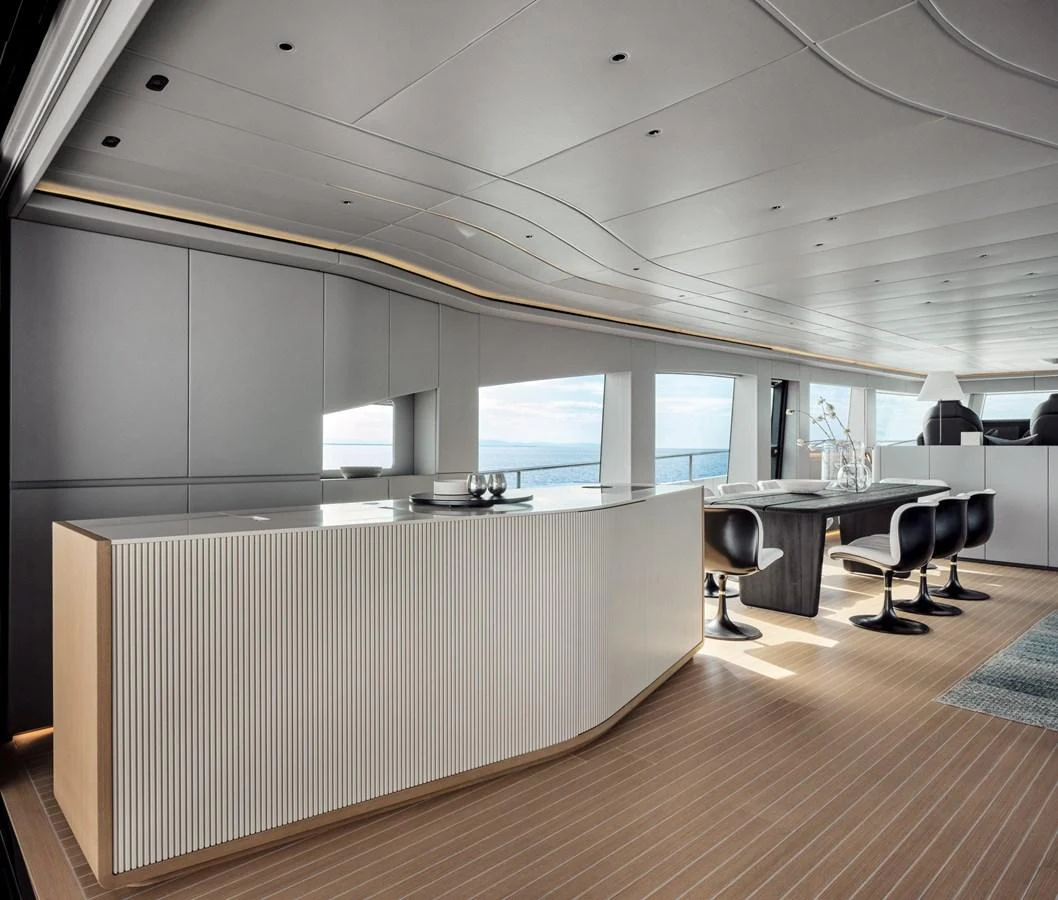 The yacht's interior features a modern and spacious design with a sleek bar area and ample seating. aboard 50 SHADES OF PLAY Yacht for Sale