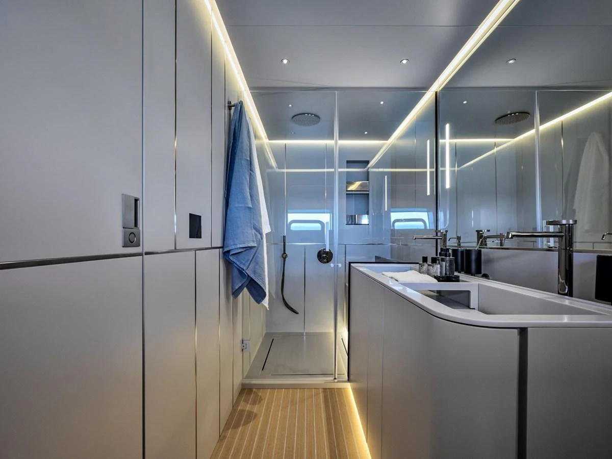 A sleek and modern bathroom with a spacious shower and elegant lighting. aboard 50 SHADES OF PLAY Yacht for Sale