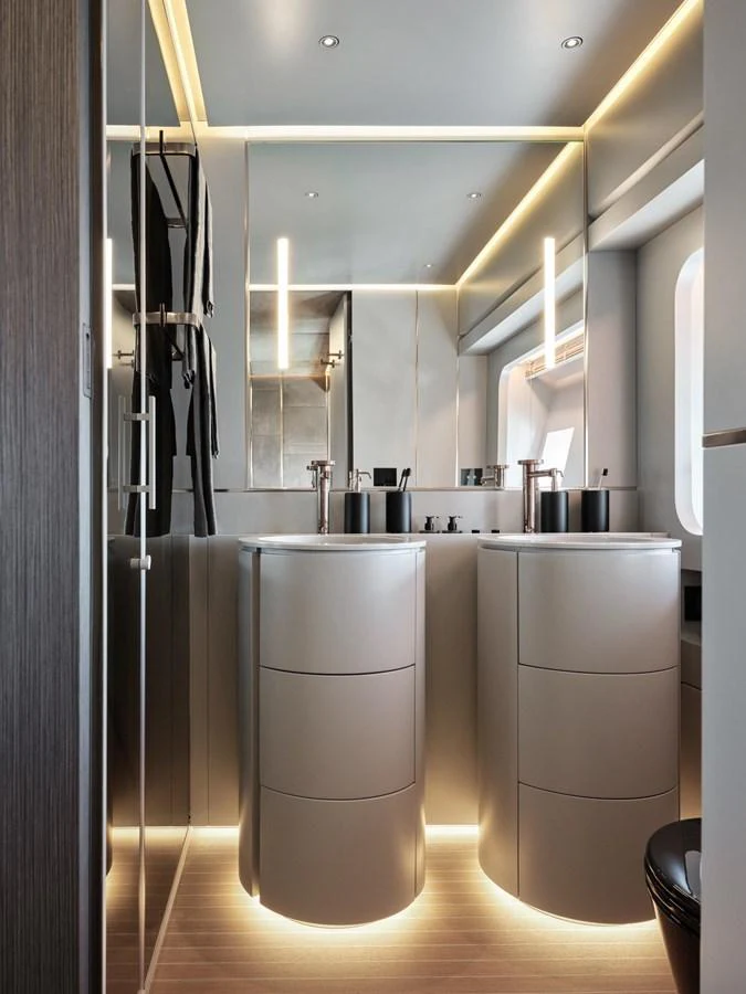A sleek and modern yacht bathroom with dual sinks and ambient lighting. aboard 50 SHADES OF PLAY Yacht for Sale
