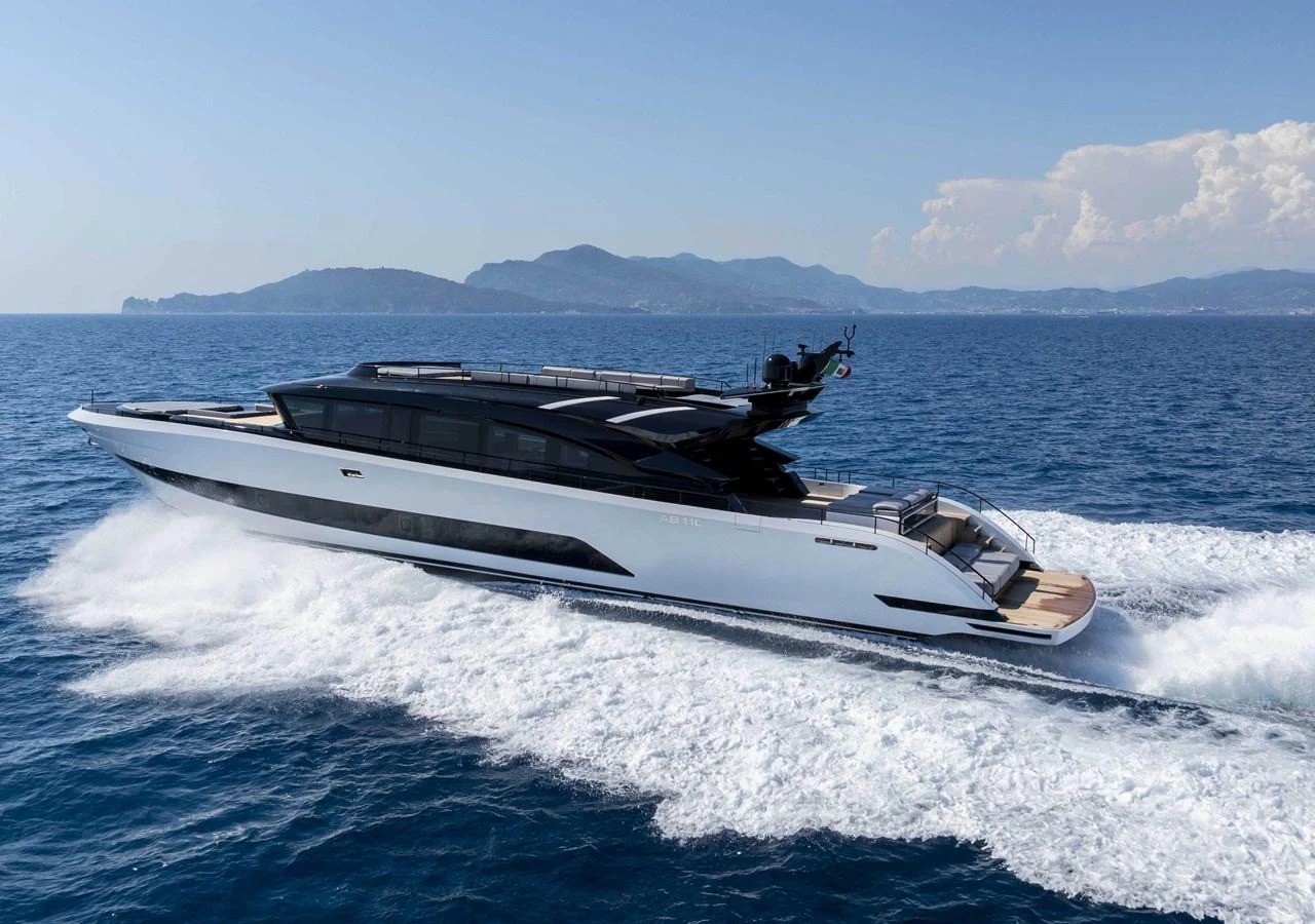 A sleek and modern yacht cruising swiftly on open waters with a scenic backdrop. aboard 50 SHADES OF PLAY Yacht for Sale