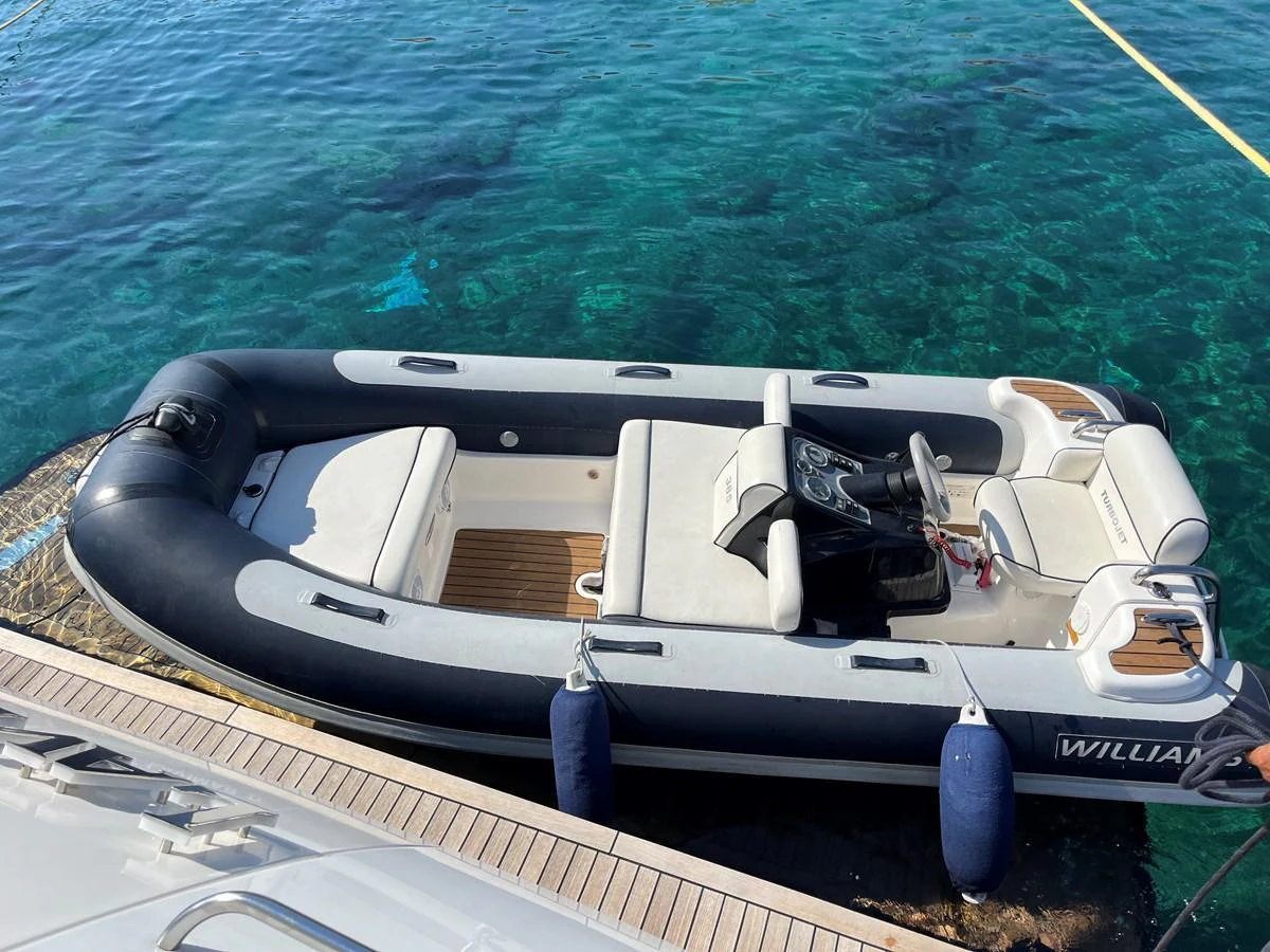 A sleek tender is docked beside a yacht, ready for excursions. aboard LAVIMAR II Yacht for Sale