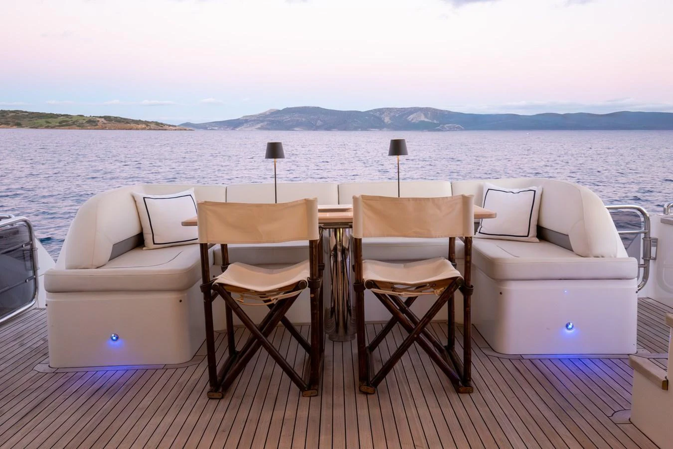 The aft deck offers a cozy seating area with a stunning view of the sea. aboard LAVIMAR II Yacht for Sale