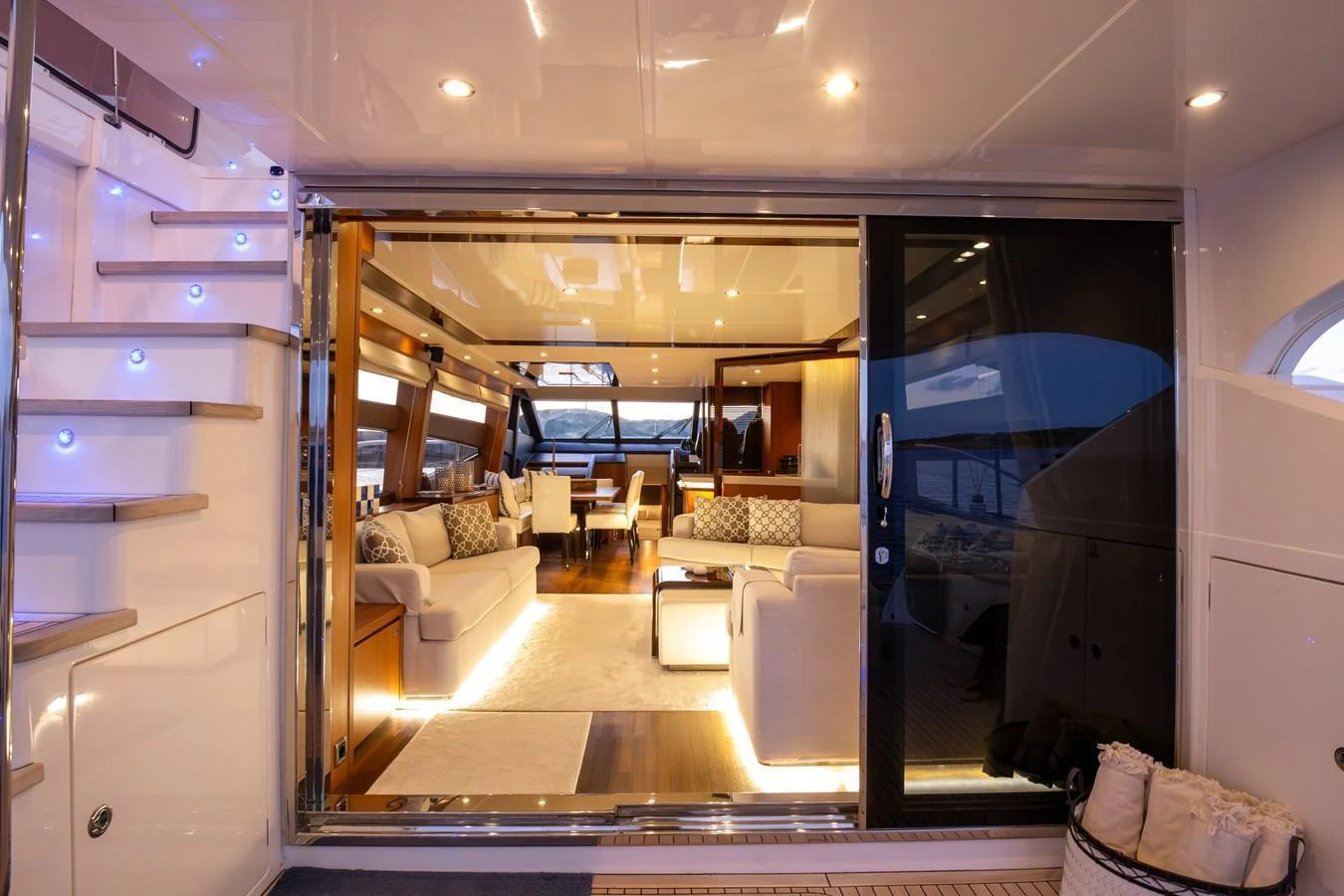 The yacht's salon features a spacious and elegantly lit seating area with modern furnishings and large windows. aboard LAVIMAR II Yacht for Sale