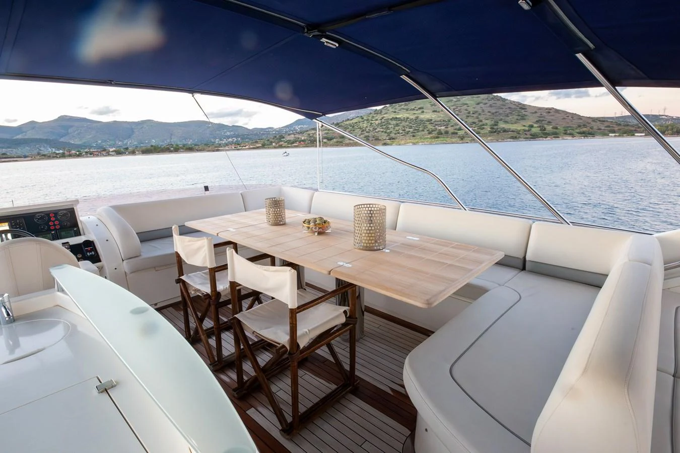 The aft deck features a spacious dining area with a large table and comfortable seating, perfect for enjoying meals with a view. aboard LAVIMAR II Yacht for Sale