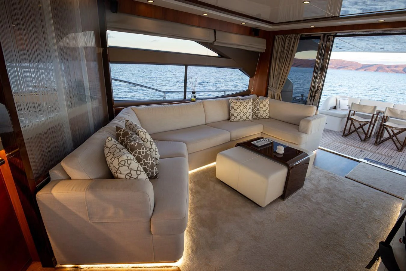 The salon features a spacious and elegant seating area with a view of the ocean. aboard LAVIMAR II Yacht for Sale