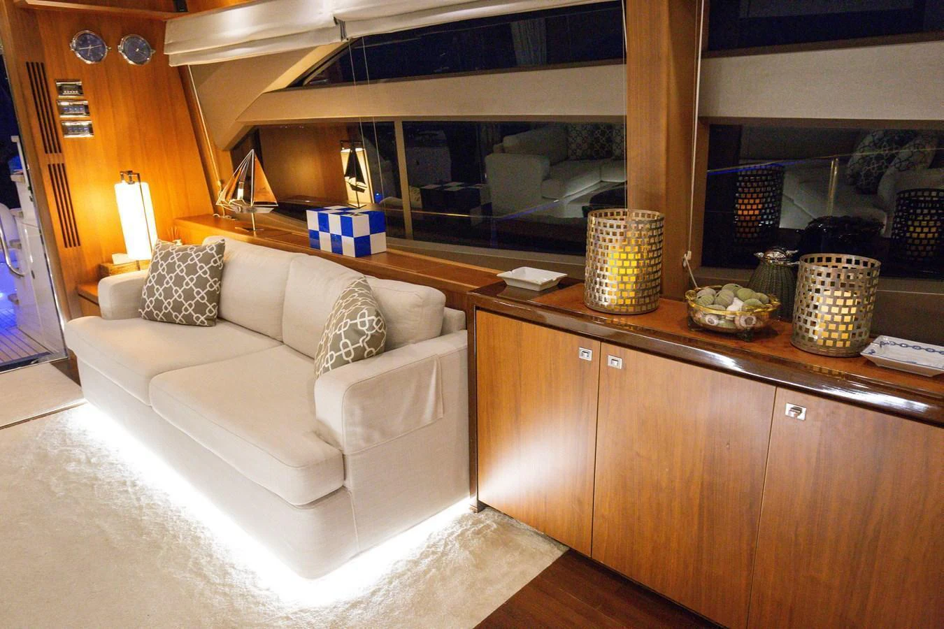 The salon features a cozy seating area with elegant lighting and stylish decor. aboard LAVIMAR II Yacht for Sale