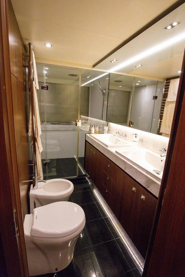 The yacht's bathroom features a sleek design with modern fixtures and a spacious shower area. aboard LAVIMAR II Yacht for Sale