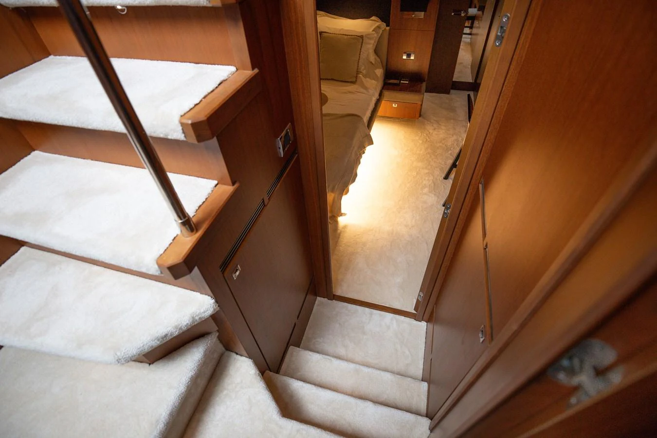 A cozy interior stairway leads to a warmly lit cabin area. aboard LAVIMAR II Yacht for Sale