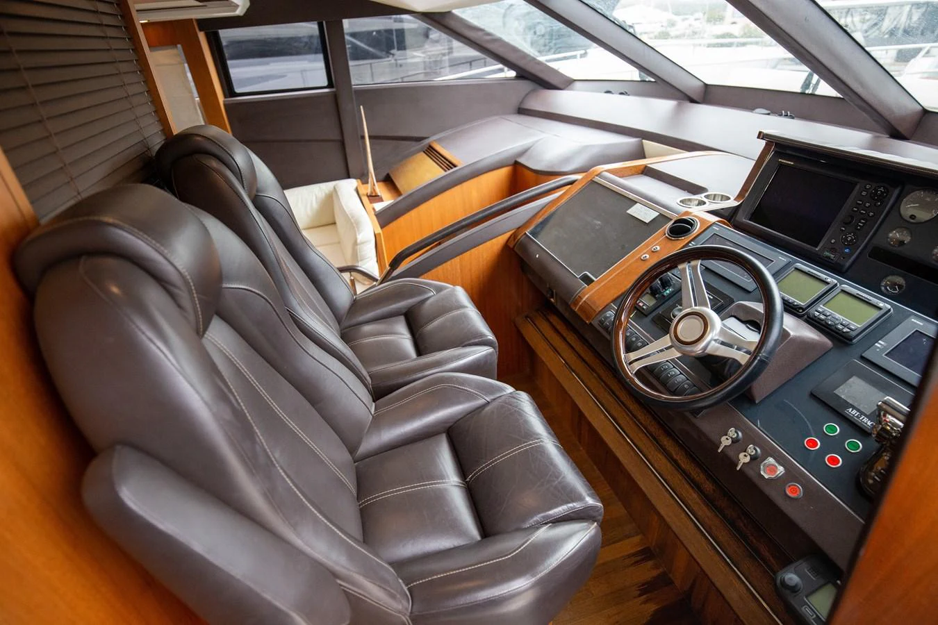 The helm station features luxurious leather seating and advanced navigation equipment. aboard LAVIMAR II Yacht for Sale