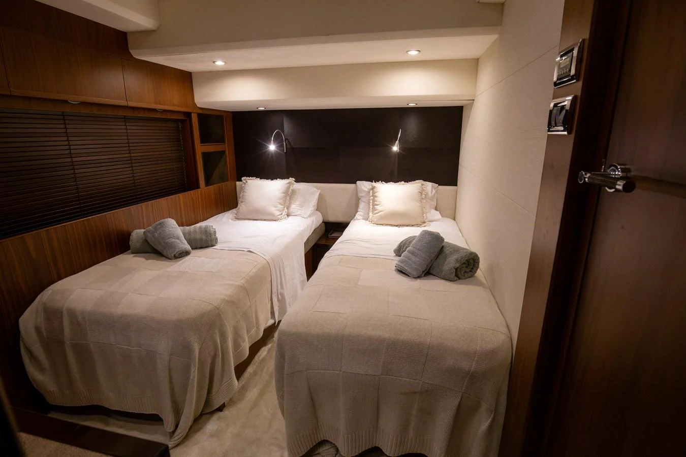 The guest stateroom features twin beds with cozy linens and ambient lighting. aboard LAVIMAR II Yacht for Sale