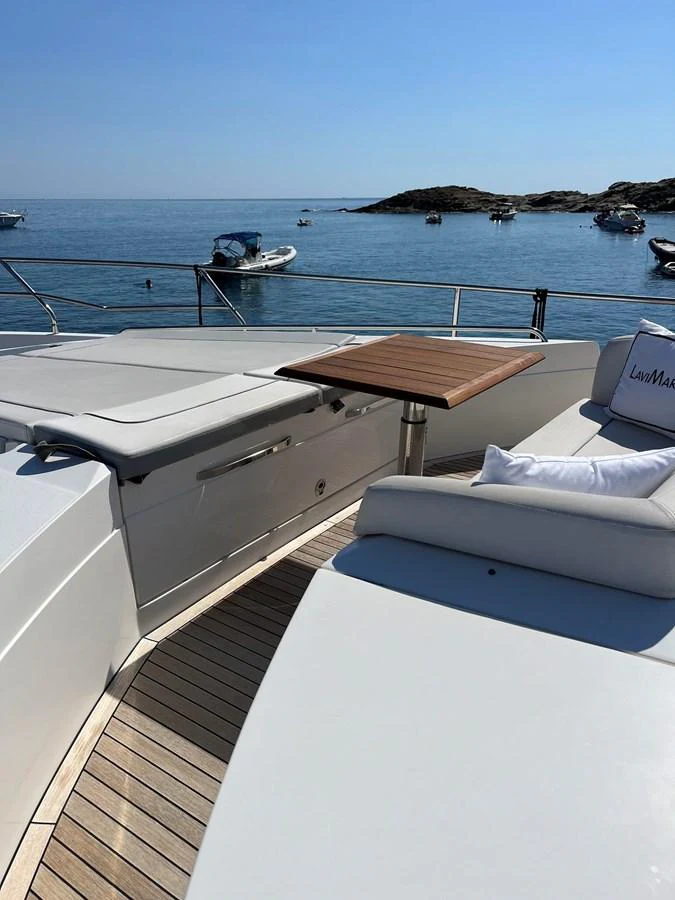 The foredeck offers a serene lounging area with comfortable seating and a stunning sea view. aboard LAVIMAR II Yacht for Sale