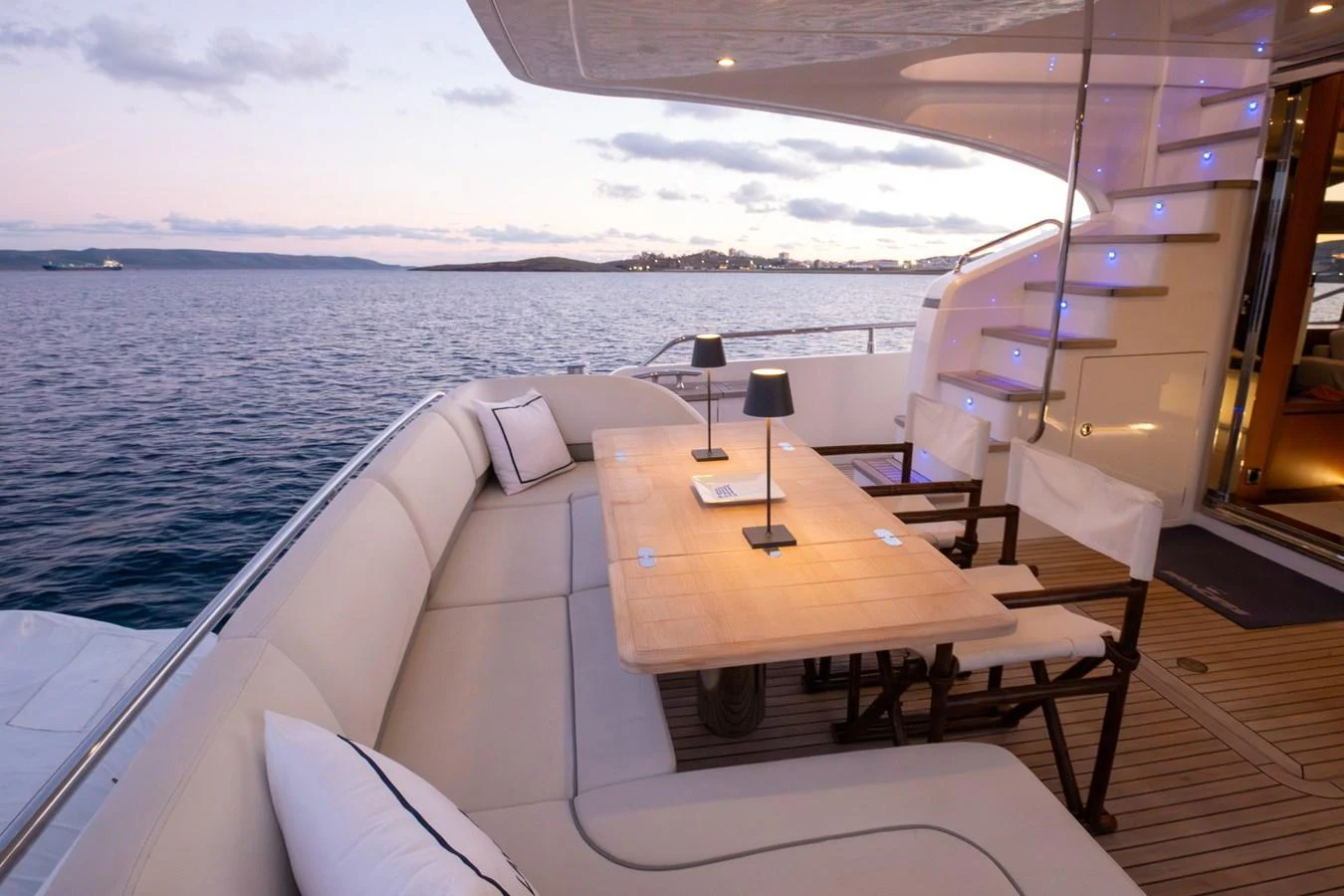 The aft deck offers a comfortable dining area with stunning ocean views. aboard LAVIMAR II Yacht for Sale